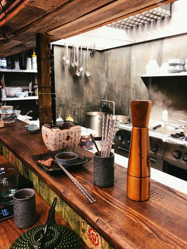 Bar and kitchen view at the Arigator Ramen Shop